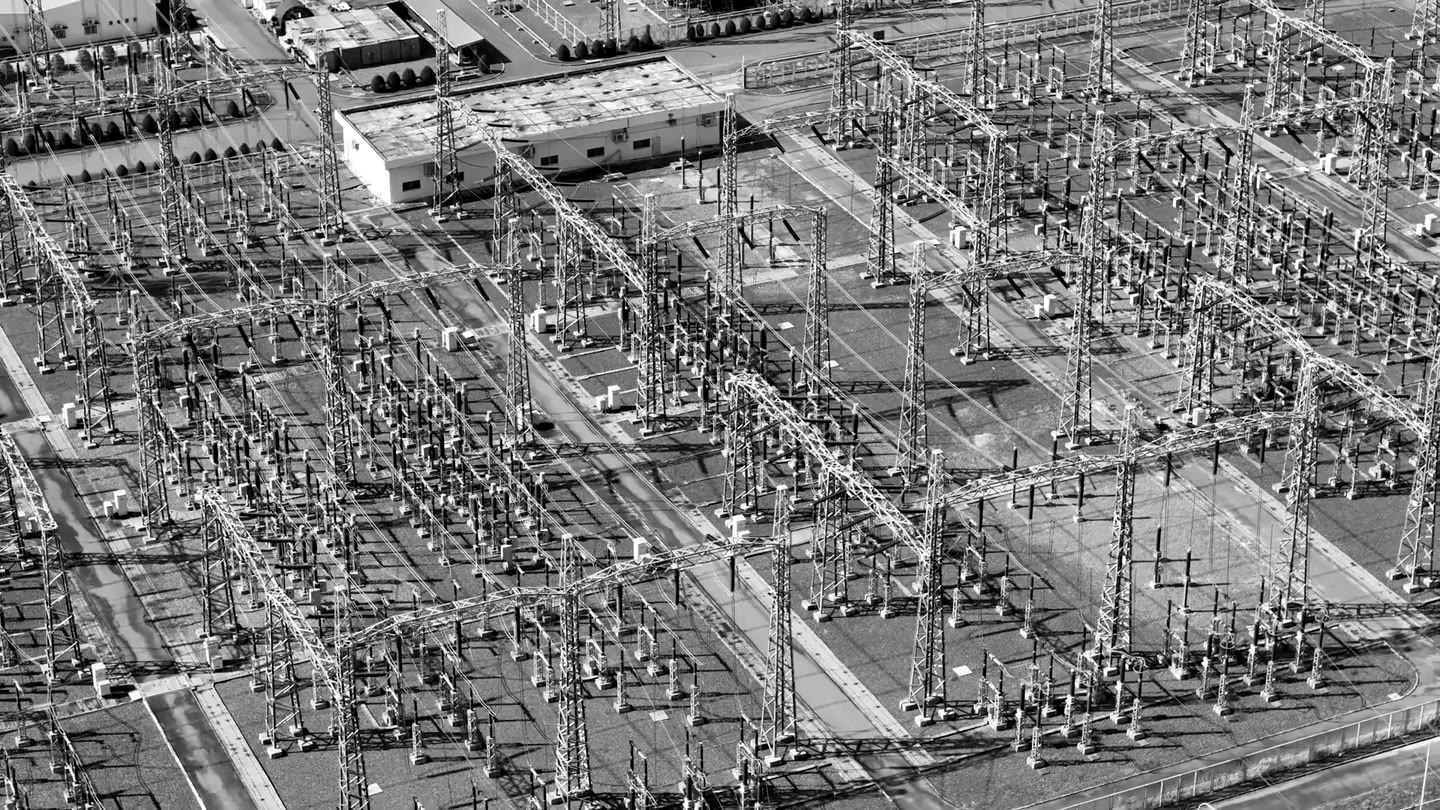 An electrical substation with interconnected transformers, switchgear, and transmission equipment.